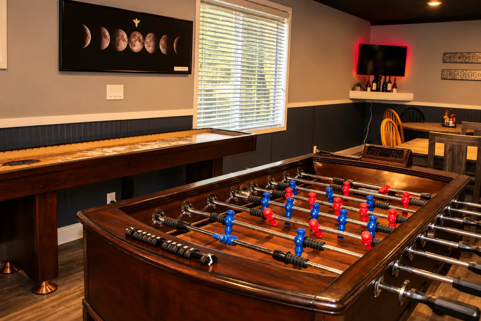 A foosball table in the lounge, beside the shuffleboard table